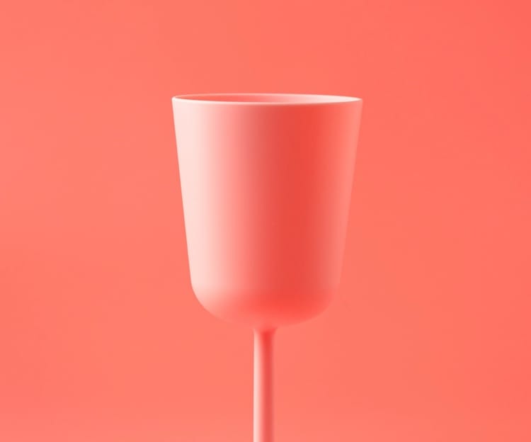 pink wine glass with a pink background